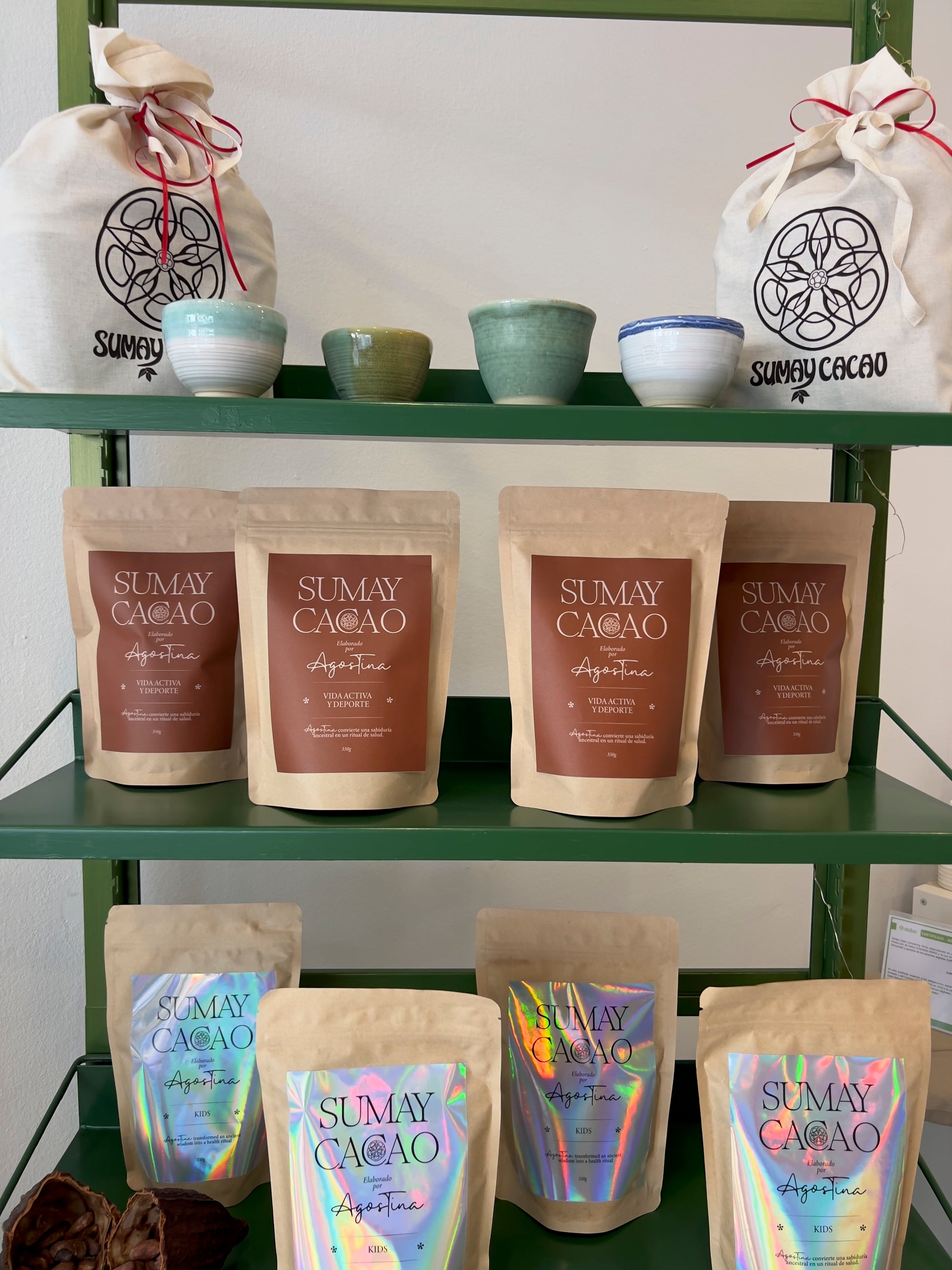Estantería con productos de Sumay Cacao y tazas de cerámica artesanal de Isa Boyd